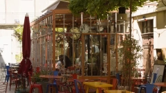 Sunny cafe terrace with colorful bistro chairs in Saint-Rémy-de-Provence.